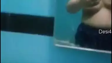Desi sweet thing touches soft natural breasts in front of a mirror